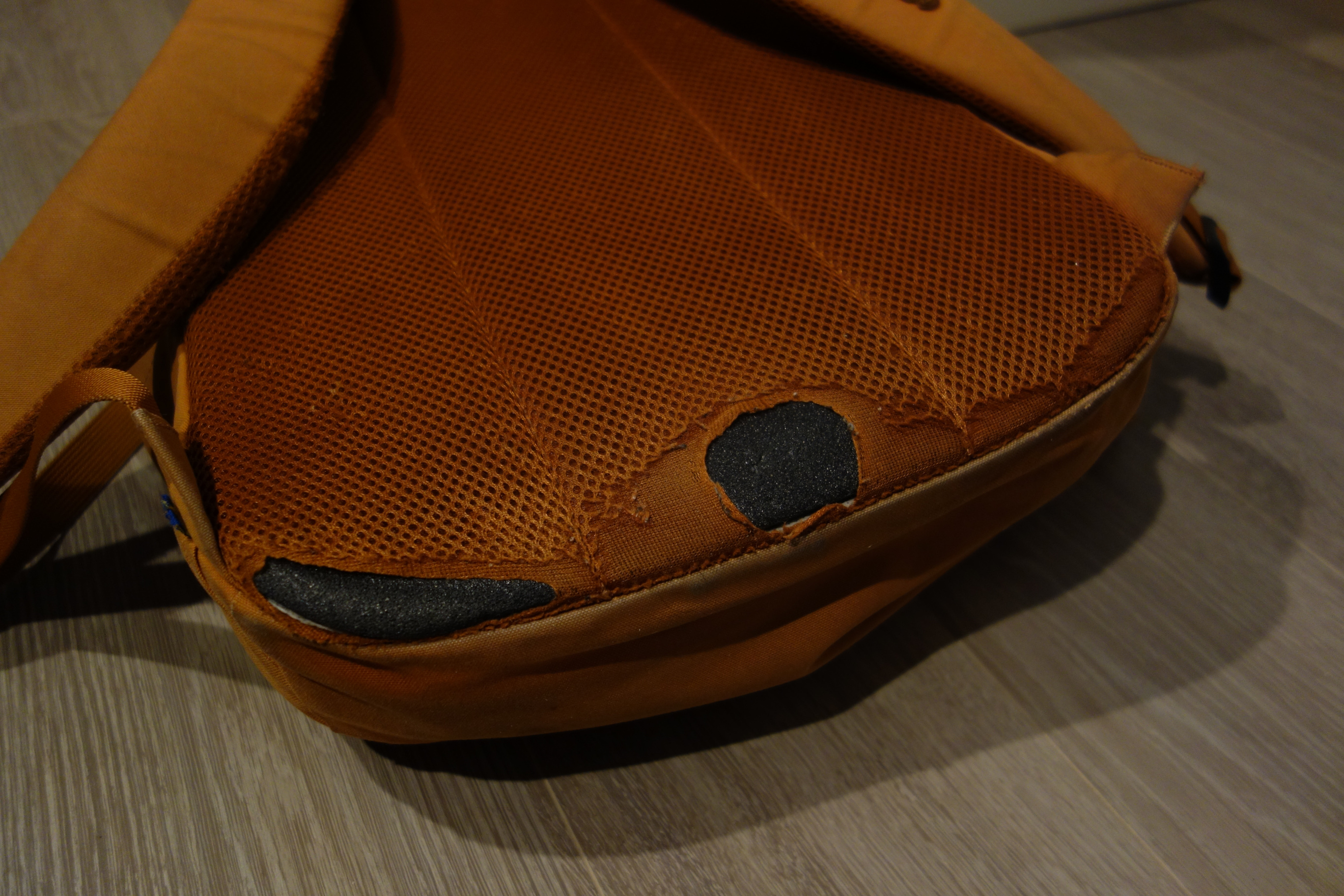Picture showing the bottom of the backpack that has been worn out.